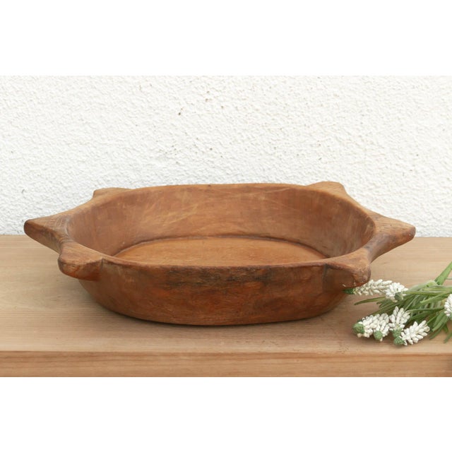 The sculptural form of this vintage bowl takes center stage. Carved from a single piece of solid hardwood, it features a...