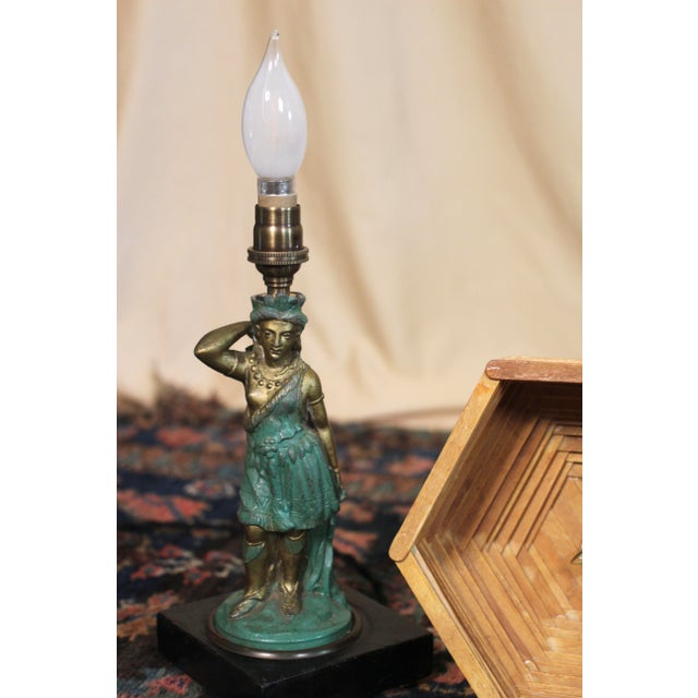 A handmade popsicle stick lampshade on top of a bronze or spelter Amazon archer woman lamp. Originally an oil l amp that...