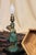 A handmade popsicle stick lampshade on top of a bronze or spelter Amazon archer woman lamp. Originally an oil l amp that...