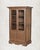 The arched glass panels in the upper doors are what stop you first. Then the ornate brass latches. Then you notice the...