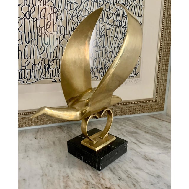 A large and impressive modern sculpture of a bird mounted on a custom marble base. We believe this piece to have been a...