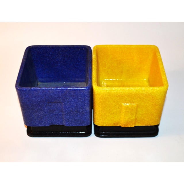 The design influenced by Mondrian and De Stijl these flower- or cactus pots from the late 1920s in primary colors are...
