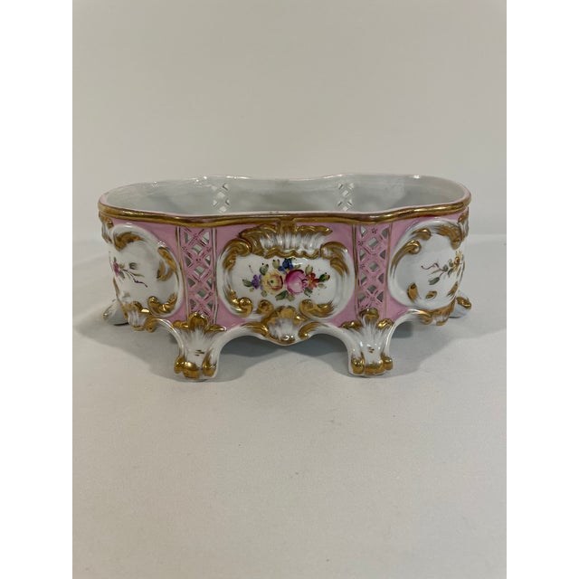 An elegant pink and gold floral French Porcelain Jardiniere by Sorelle, circa Mid 20th Century. Maker's stamp on the...