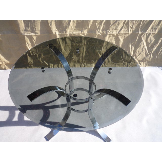 Black smoked glass dining table with chrome cabochons on a chromed steel base. The table is very stable and in excellent...
