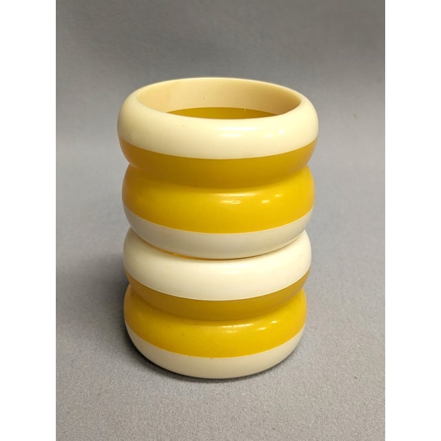 Offering a set of eight yellow striped melamine napkin rings by Diane von Furstenberg Home. The 2 sets of four napkin...