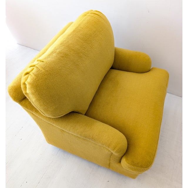 Huge squashy swivelling armchairs. Made by Kravet, USA, late 1970s. Newly reupholstered in an ochre yellow fluffy mohair...