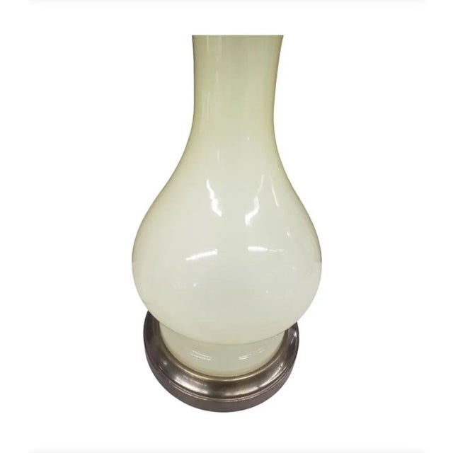 Mid-Century Celadon Glazed Porcelain and Brass Table Lamp, measuring 6" in diameter and standing 26.5" tall to the top of...