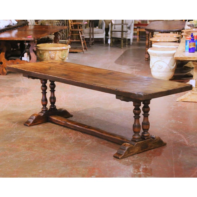 This French Louis XIII style monastery dining table was crafted in the Pyrenees region of France circa 1950 using...