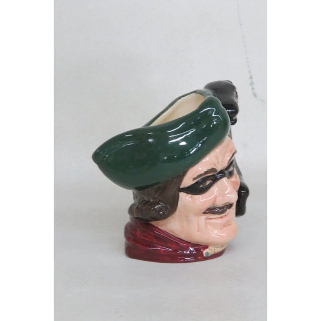 This charming Small Character Toby Jug is made of painted ceramic. The piece is stamped as being made in England by Royal...