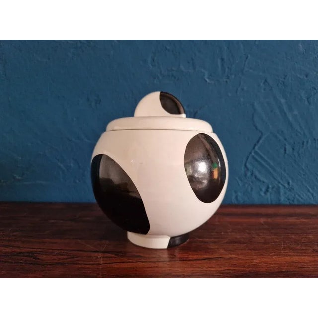 The ceramic lid box was a gift from Michele de Lucchi in 1984. The decor can be found in some of its furniture designs....