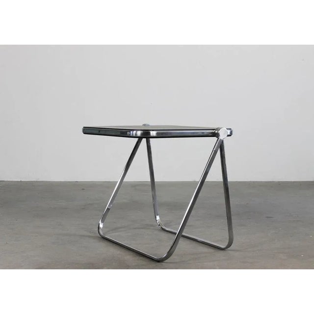 Platone folding table or desk with structure in chromed steel and die-cast aluminum, table top in black ABS. Designed by...