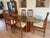 Danish Benny Linden teak dining set with mid-century table with a sculpted multi-pedestal teak base and original curved...