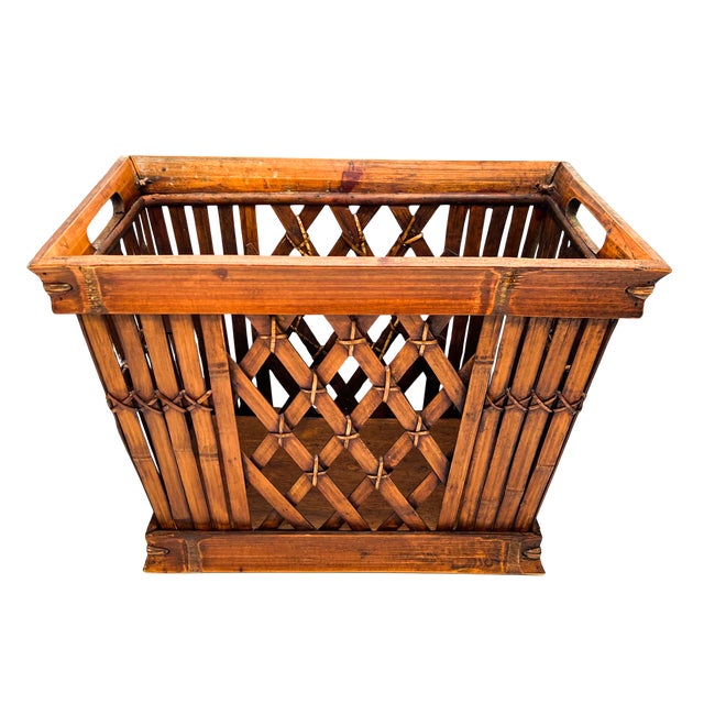 Handcrafted, mid-late 20th century bamboo and rattan storage basket featuring warm honey-brown coloring, decorative open...