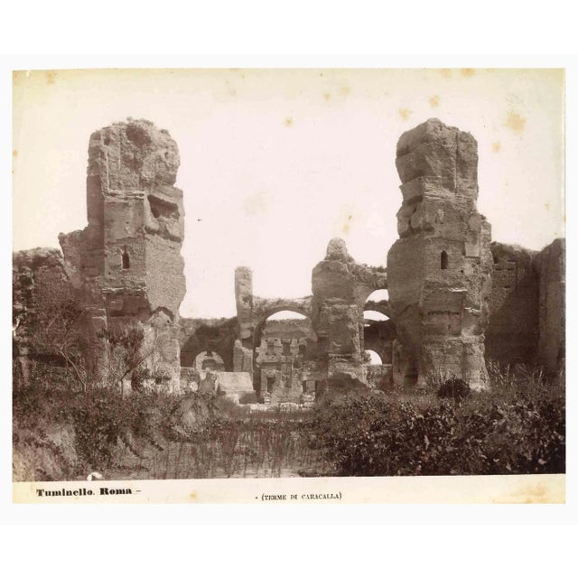 Baths of Caracalla is a vintage sepia photograph realized by Ludovico Tuminello in the early 20th Century. Titled on the...