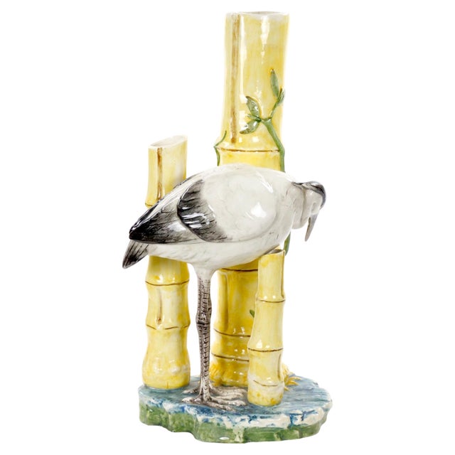 This mid-century modern Italian majolica sculpture depicts a graceful heron standing amid a vibrant pond scene with...