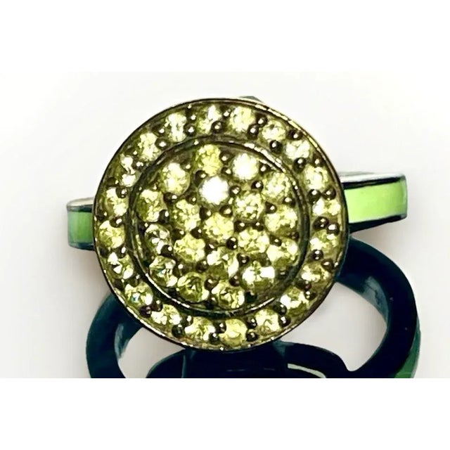 Cluster ring of vibrant subdued yellow and green sapphire gemstones on mint green band. Created by renowned designer,...