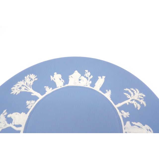 A vintage Wedgwood pale blue Jasperware decorative plate, made in England. The "Greek Procession" pattern features The...