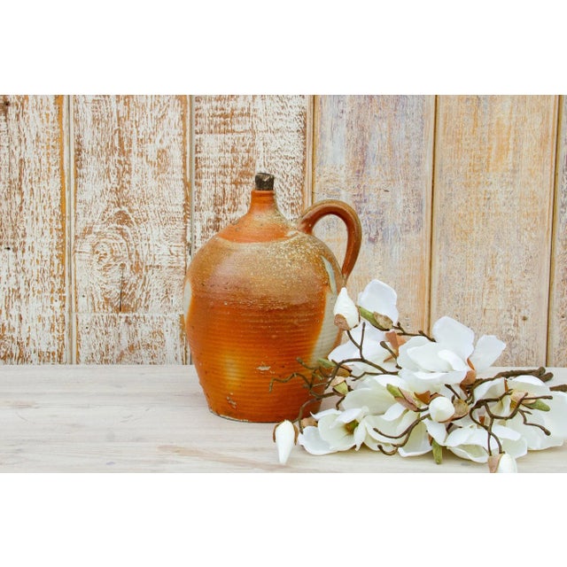 Charming early to mid 20th century baluster jar from the Normandy region in France. This antique jug was used to store or...