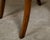 A pair of English oak stools from the 19th century with saber legs and custom upholstery. This pair of English oak stools...