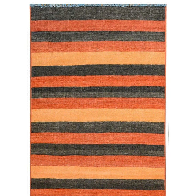 A fantastic bold vintage Turkish Konya Kilim runner with an alternating orange, crimson and black striped pattern.