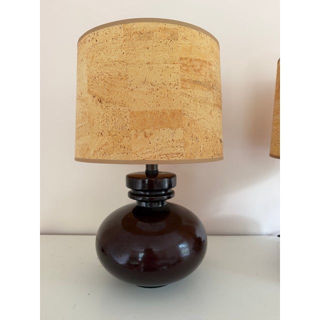 A pair of beautiful mid-century ceramic lamps in brown glaze with classic drum lampshades crafted from natural cork...