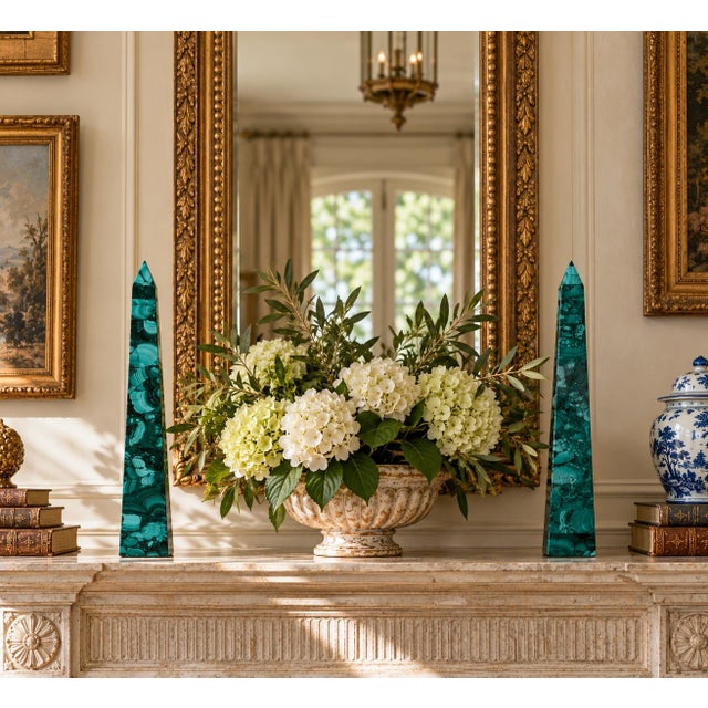 A beautifully proportioned pair of malachite obelisks in richly veined shades of green and black. The sculptural...