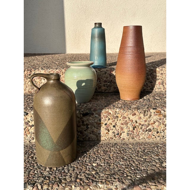 A striking, handcrafted stoneware vase from the GDR, featuring finely crafted incised and chip-carved decoration. The...