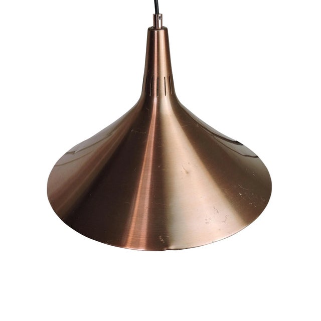 This bronze colored Danish designed pendant light is in brushed aluminum. This piece is attributed to the mentioned...