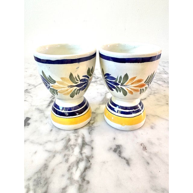 Henriot Quimper egg cup, a type of French pottery from Brittany, France, known for its hand-painted designs featuring...