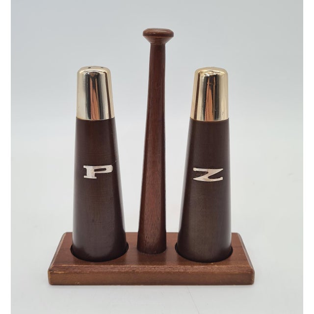 An original vintage tableware set made of beautifully grained teak wood, consisting of two spice containers and a wooden...