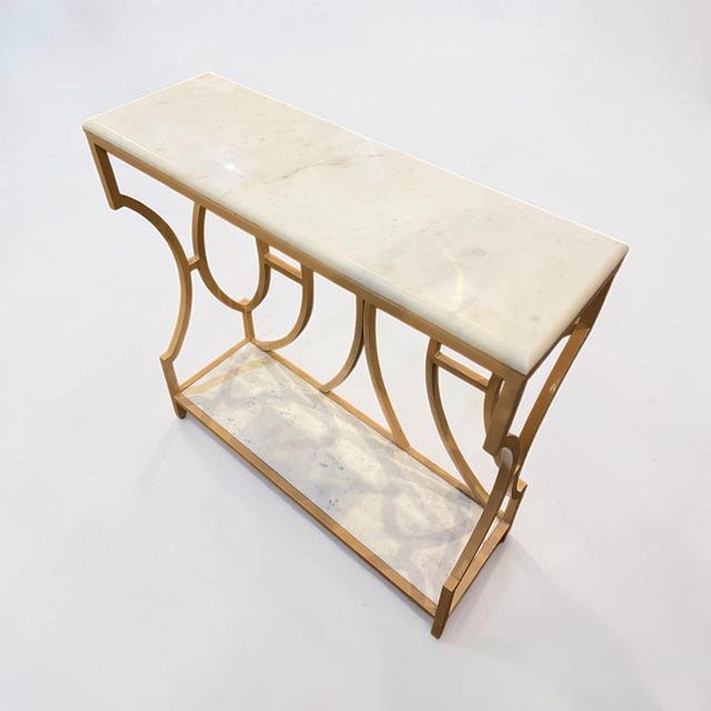 This very elegant Deco style console table has curved gold iron with solid marble top and base. this beautiful piece could...