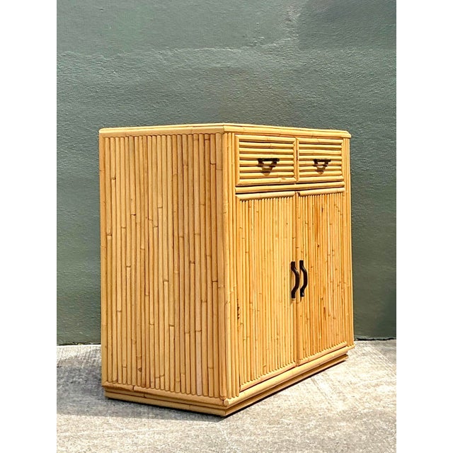 Elevate your interior with this striking vintage stacked bamboo sideboard, a quintessential piece that blends 1970s...