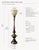 A striking 1960s–1970s sculptural torch-form table lamp featuring rich aged brass, glossy black enamel accents, and an...