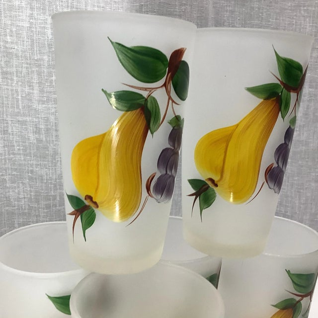 Offering a set of 6 Mid-Century Frosted Glassware. The finish is frosted and the pear and grape cluster with leaves is...
