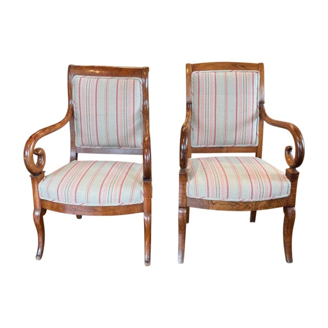 A fine pair of Charles X armchairs with scrolled arms and saber legs. Recently recovered in a striped fabric.