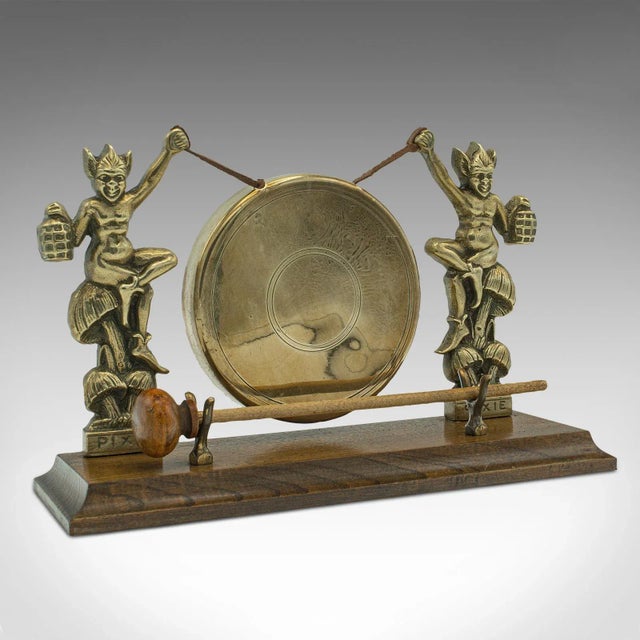 This is an antique Cornish Pixie gong. An English, brass and oak dinner chime, dating to the late Victorian period, circa...