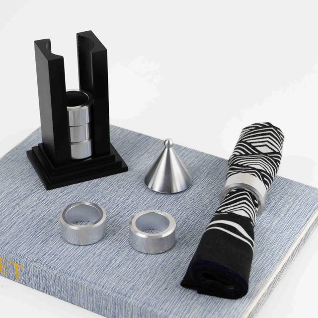 Charming vintage napkin ring holder crafted in the shape of a miniature building with six silver-colored metal napkin...