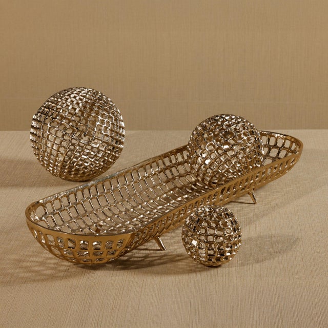 Bring sculptural elegance and a touch of shine to any surface with this oval decorative tray, crafted from aluminum and...