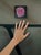 This oil painting presents a single pink rose, rendered with meticulous detail against a dark background that enhances its...