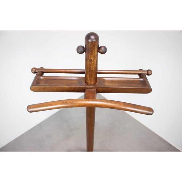 A practical and elegant vintage wooden valet stand from Czechoslovakia, dating to circa the 1960s.This vintage bentwood...