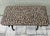 Vintage bench that is constructed from a patinated metal base (likely cast iron or bronze) and is paired with an animal...
