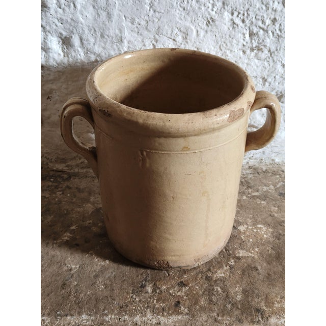 This glazed terracotta two-handled salad bowl is handcrafted in Southern Italy. Its cylindrical shape, thick rim, and two...