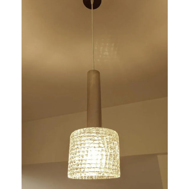 Set of 3 large Vintage mid century pendant light featuring a cylindrical structured murano glass shade mounted on an...