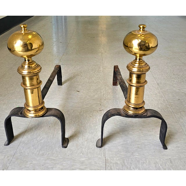 Pair 18th Century Early American Brass and Iron Canon Ball Andirons. Measure 10" in width, 21" in depth and 16" in height.