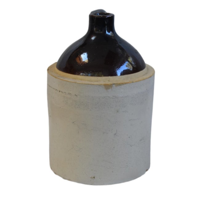 Beautifully balanced antique stoneware jug with a two-tone design, featuring a rich, dark brown Albany slip-glazed upper...