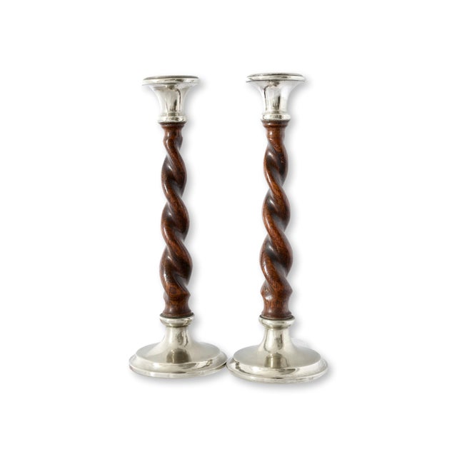Pair of early 20th century English oak twist candlesticks with silver plateed mounts and detailing. The hand turned barley...