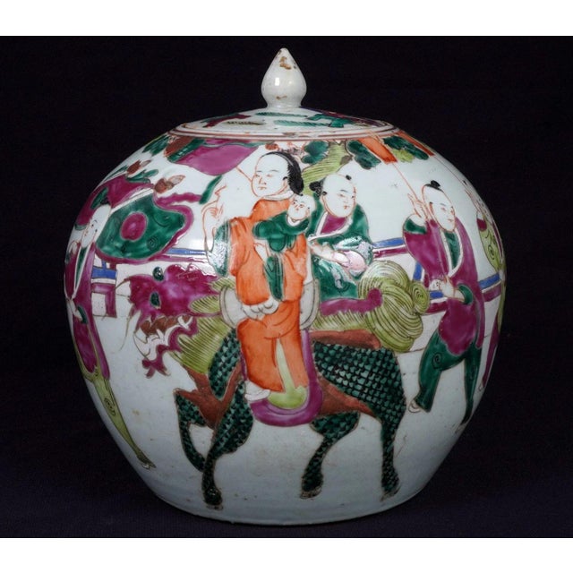 A decorative pair of Chinese porcelain ginger jars, each finished in the traditional Famille Rose palette. Both jars...