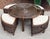 This is a vintage rattan round cocktail or game table with four benches, finished in dark brown rattan with palm-patterned...