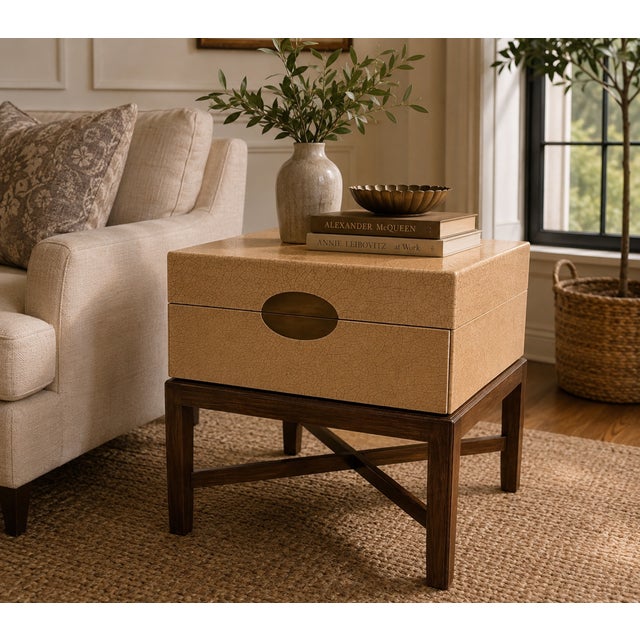 A Marge Carson taupe craquelure box table with a bronze front, set on a medium dark walnut cross stretcher base and...