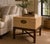 A Marge Carson taupe craquelure box table with a bronze front, set on a medium dark walnut cross stretcher base and...